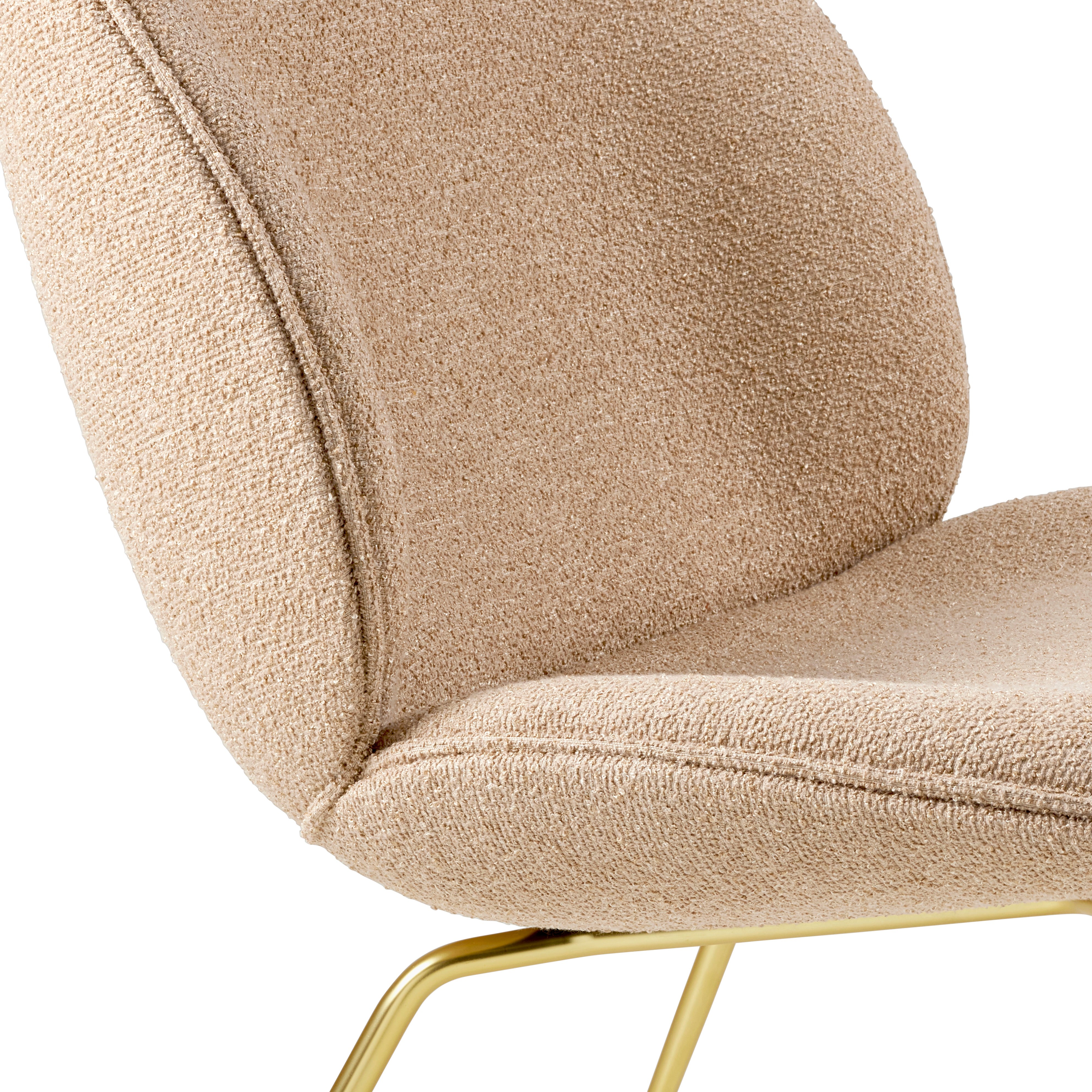 BEETLE armchair upholstered with a gold base