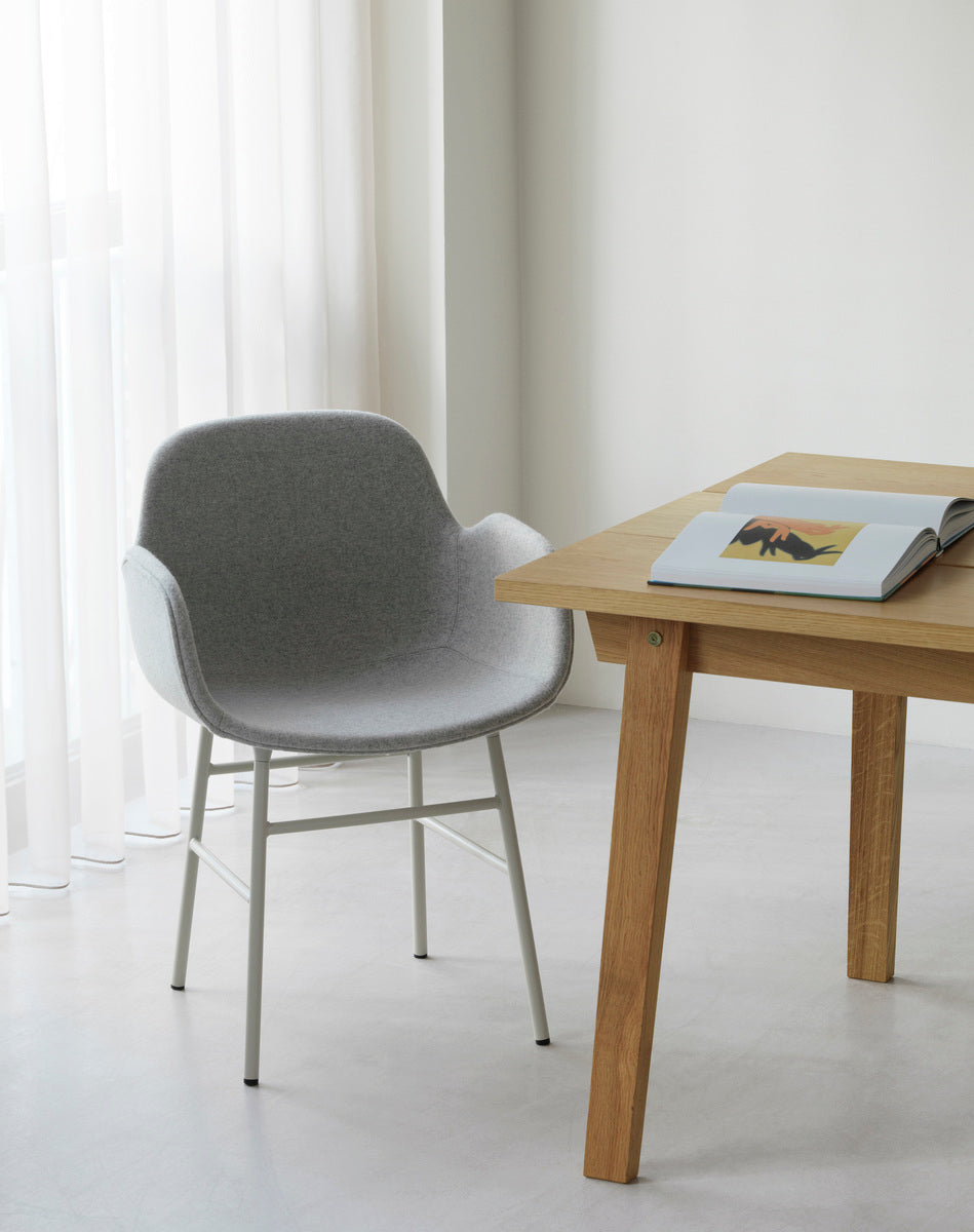 Upholstered chair with armrests of forms with a red base