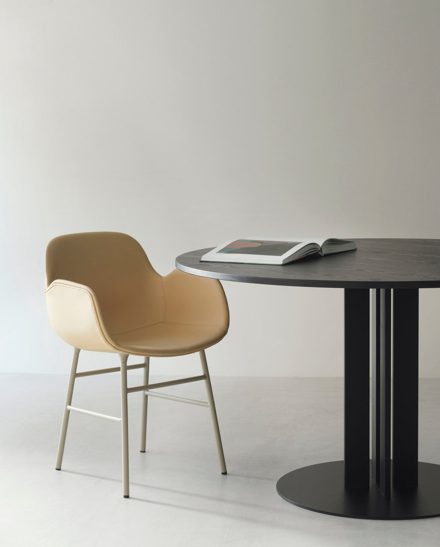 Upholstered chair with armrests of forms with a red base