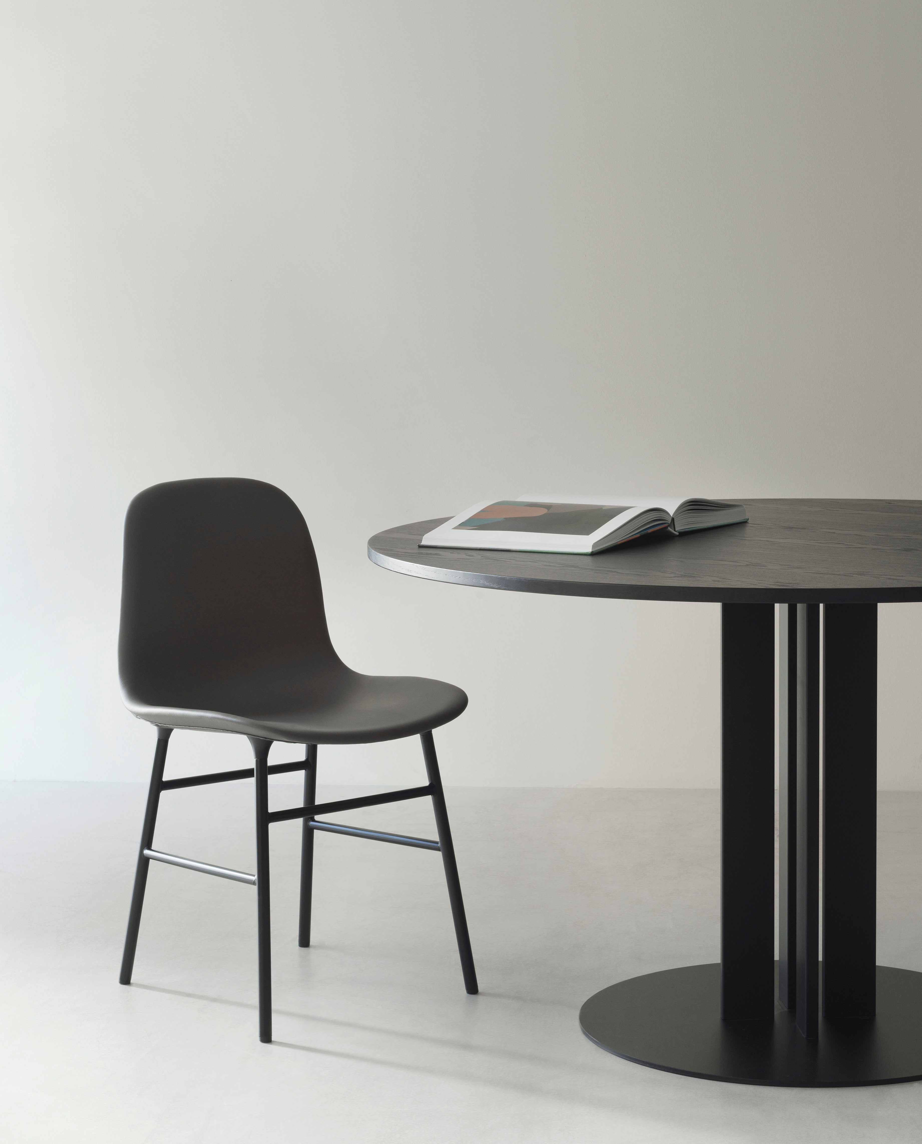 A chair of forms warm gray with a chrome base