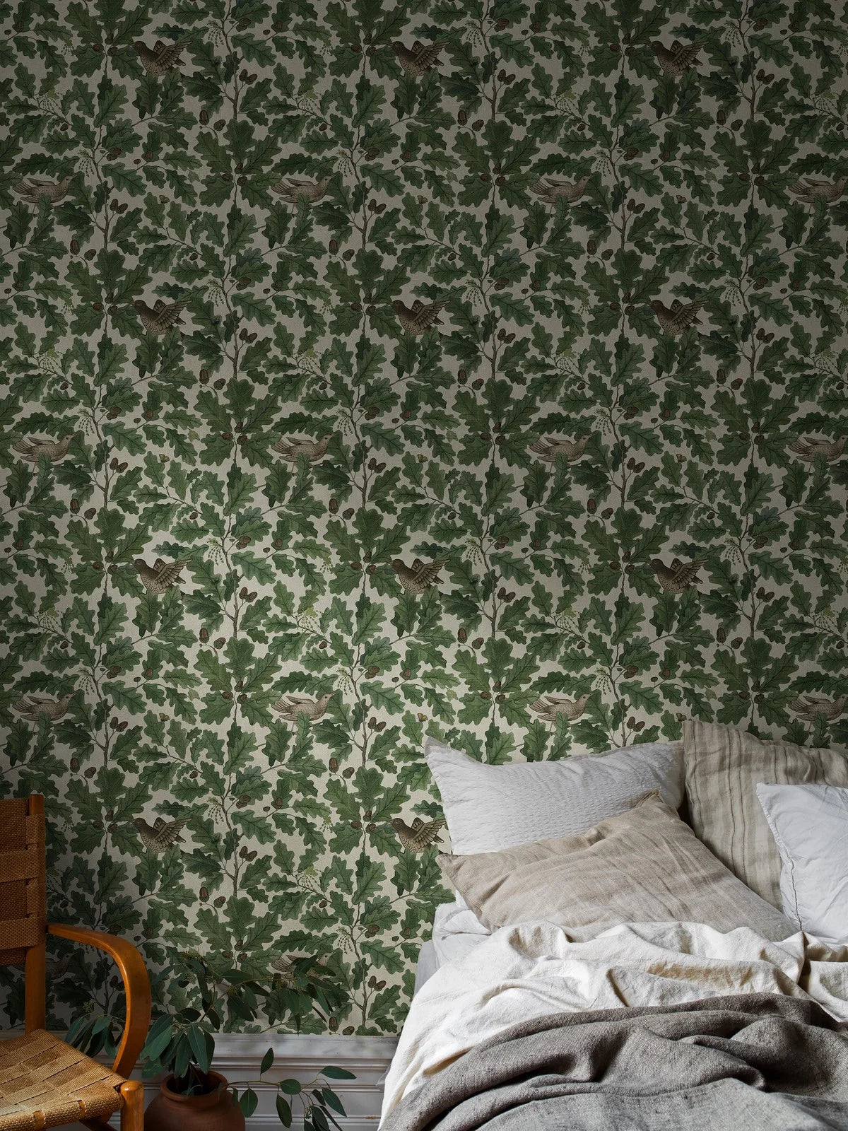 Wallpaper with a plant motif of leaves and birds IN THE OAK green with white