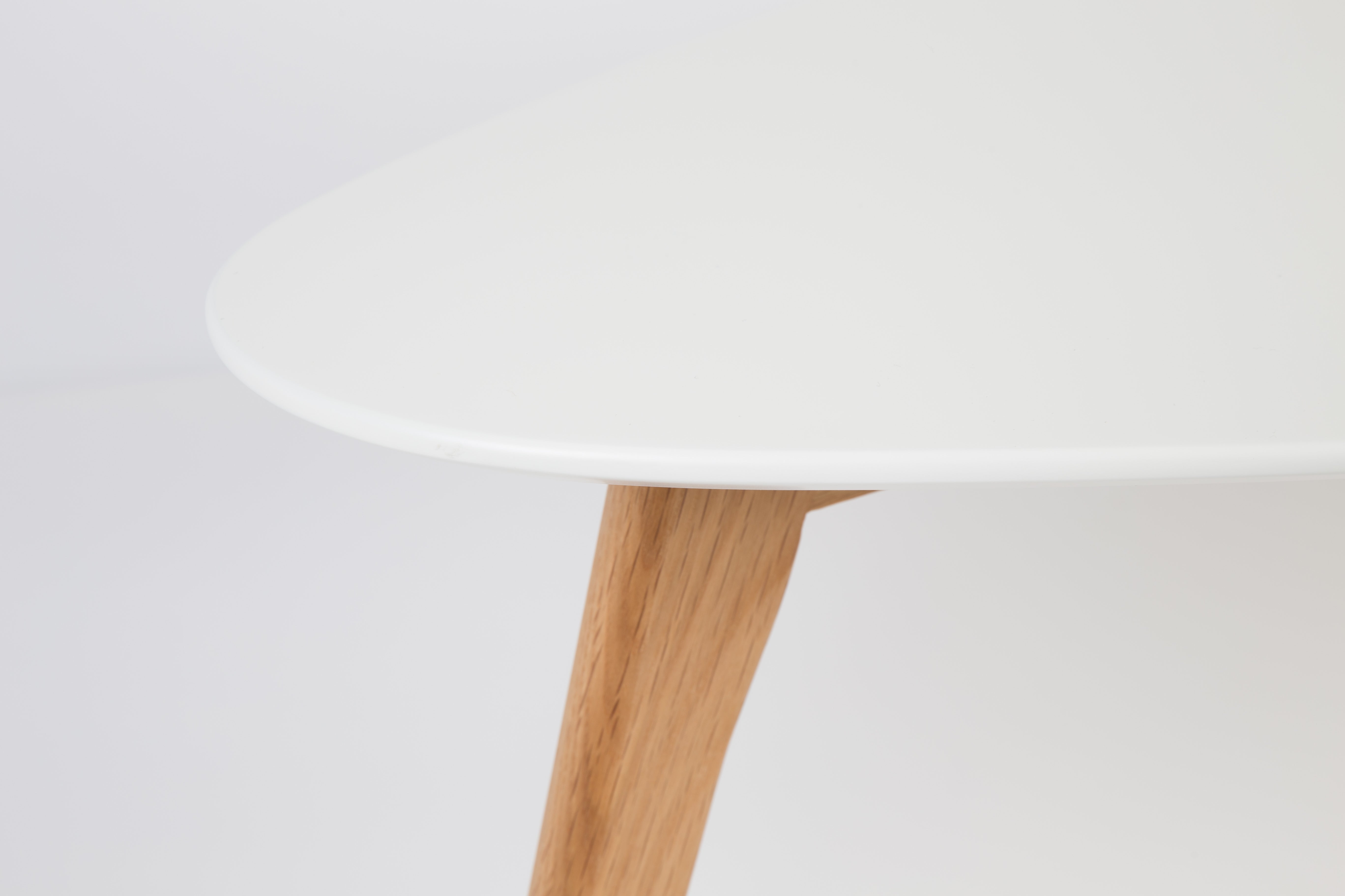 A set of white drop tables with a wooden base