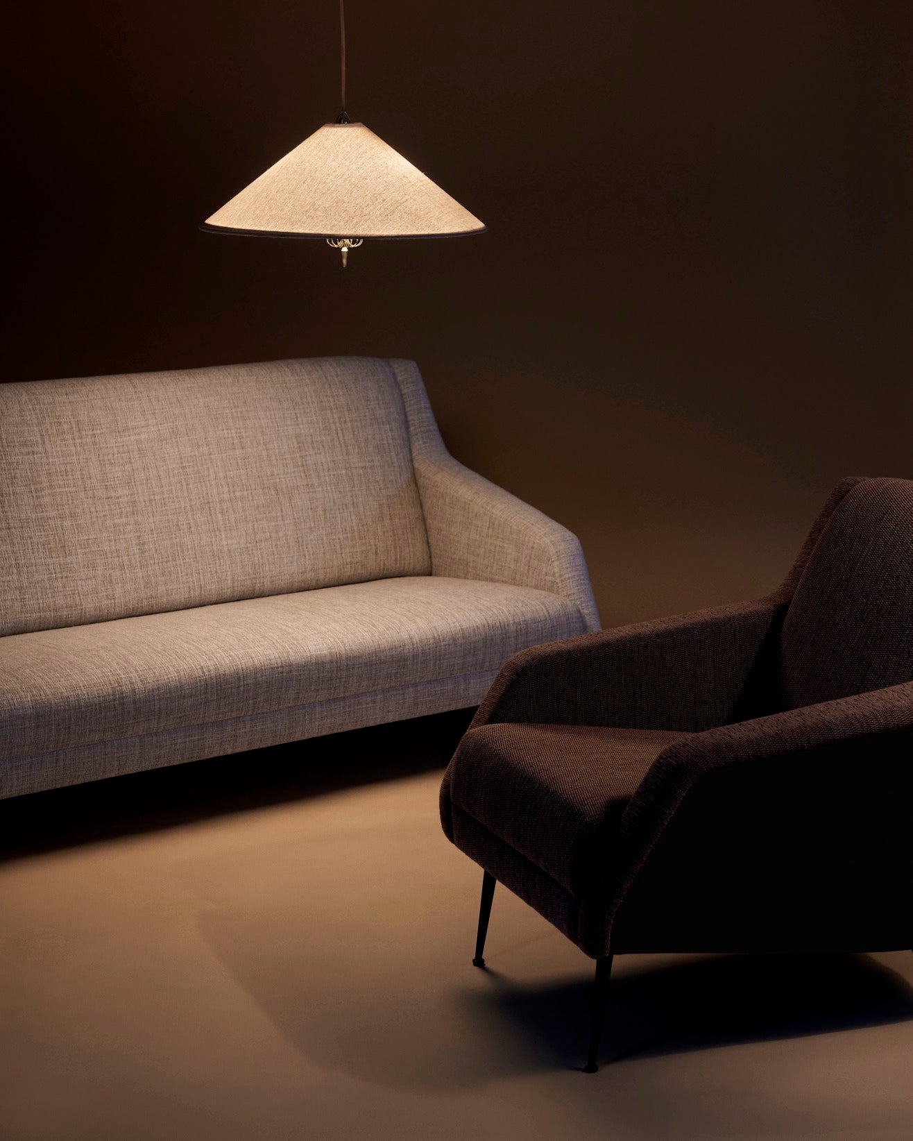 CDC.1 upholstered armchair with a black base