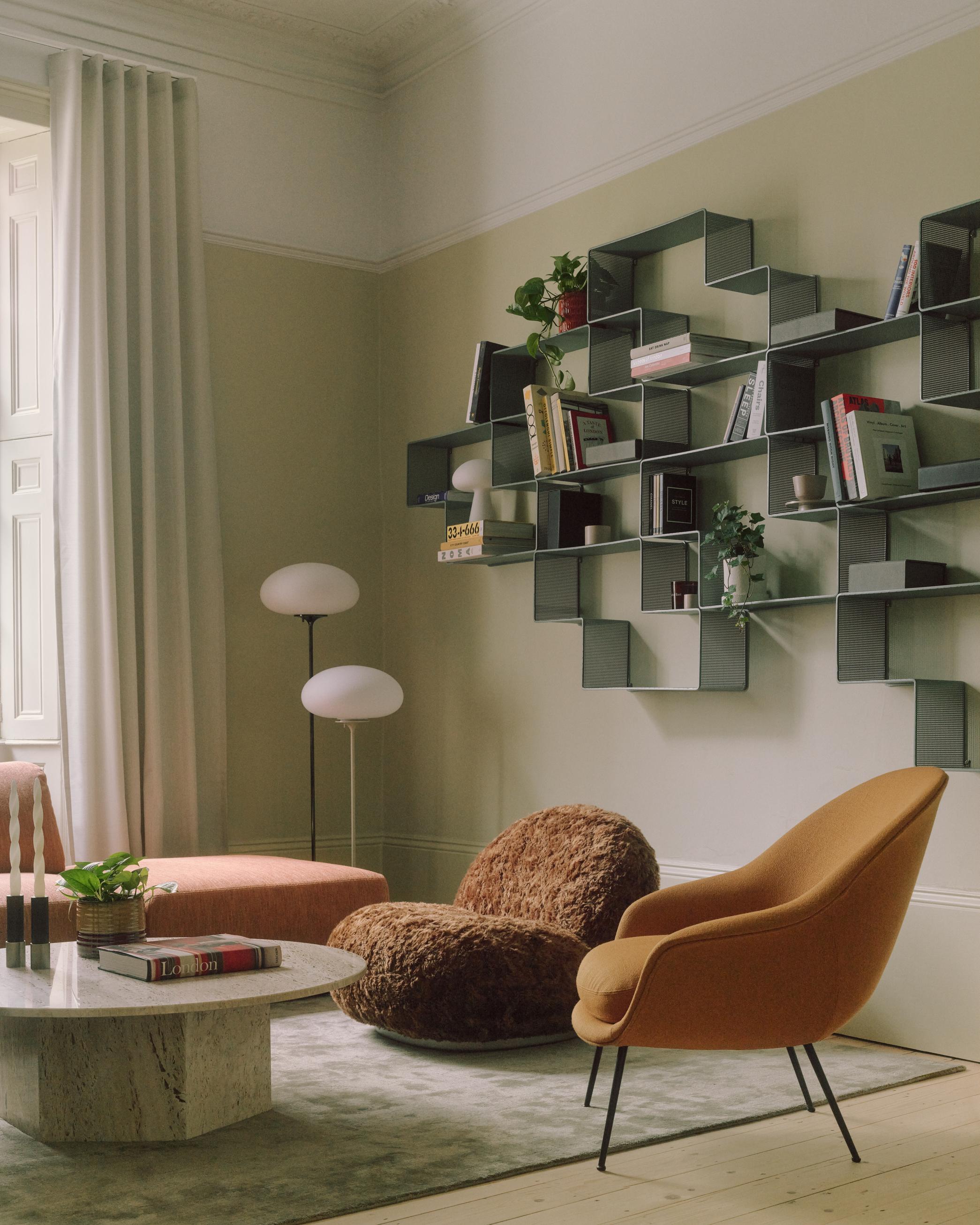 Upholstered BAT armchair with brass base