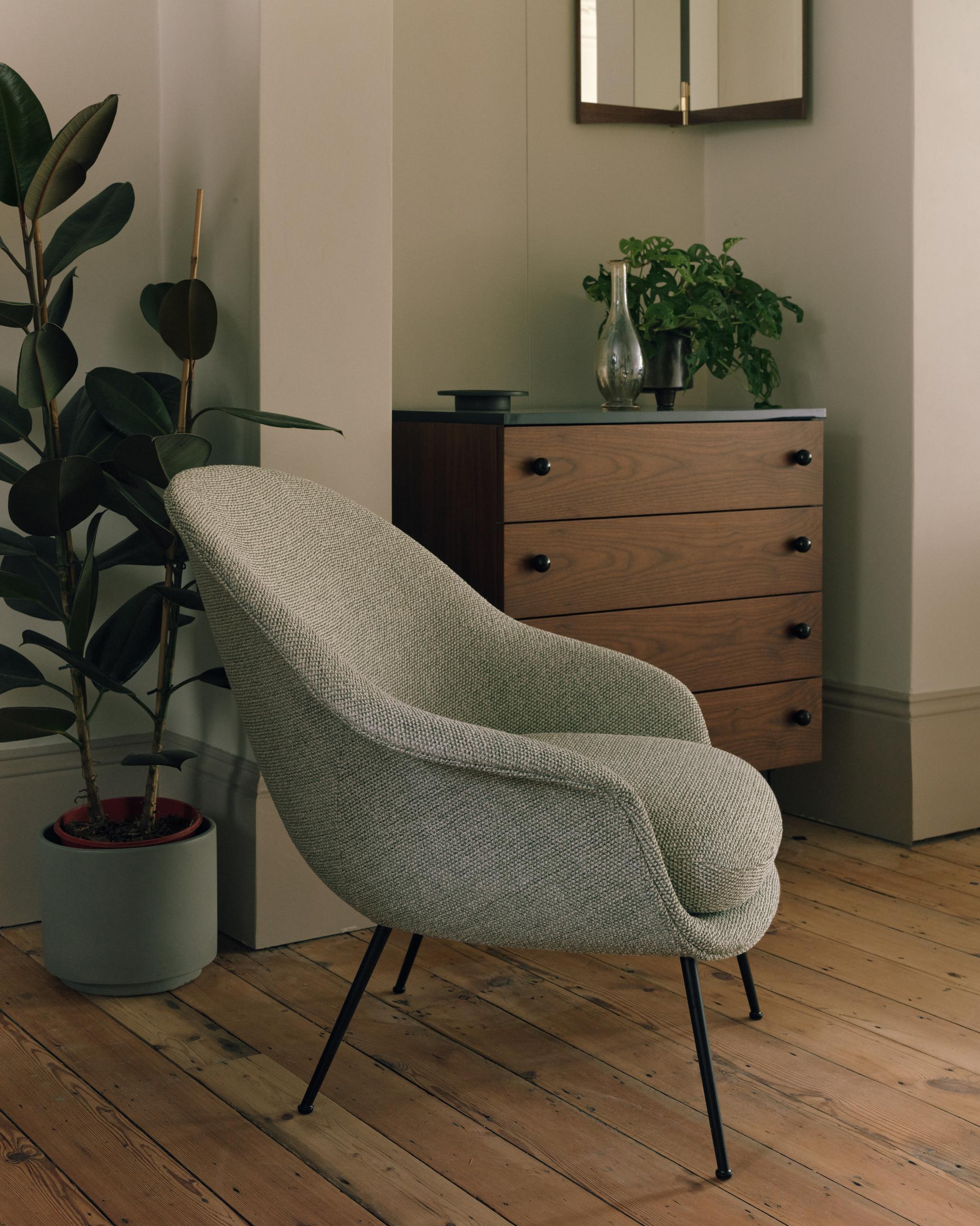 Upholstered BAT armchair with brass base