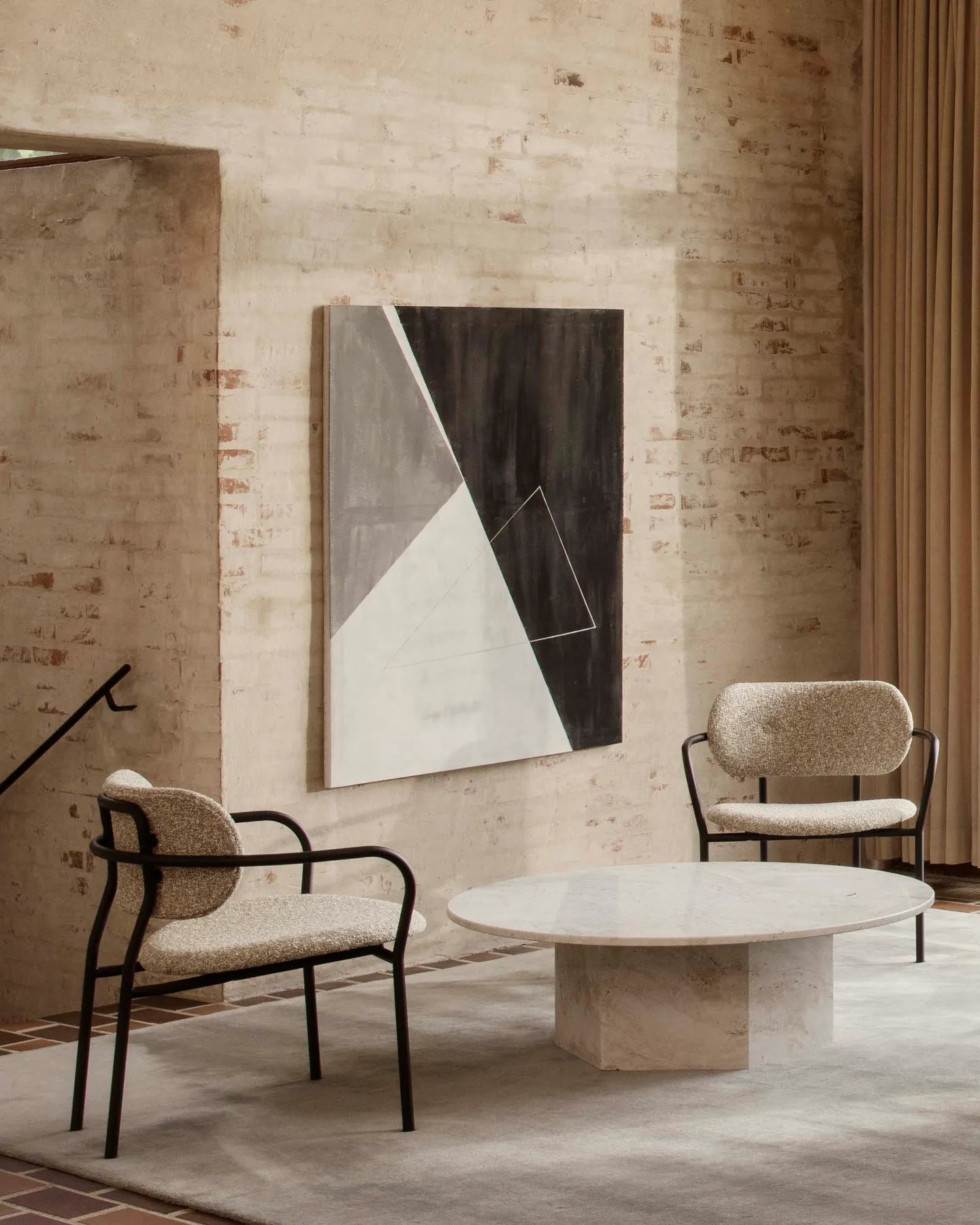 COCO upholstered armchair with a black base