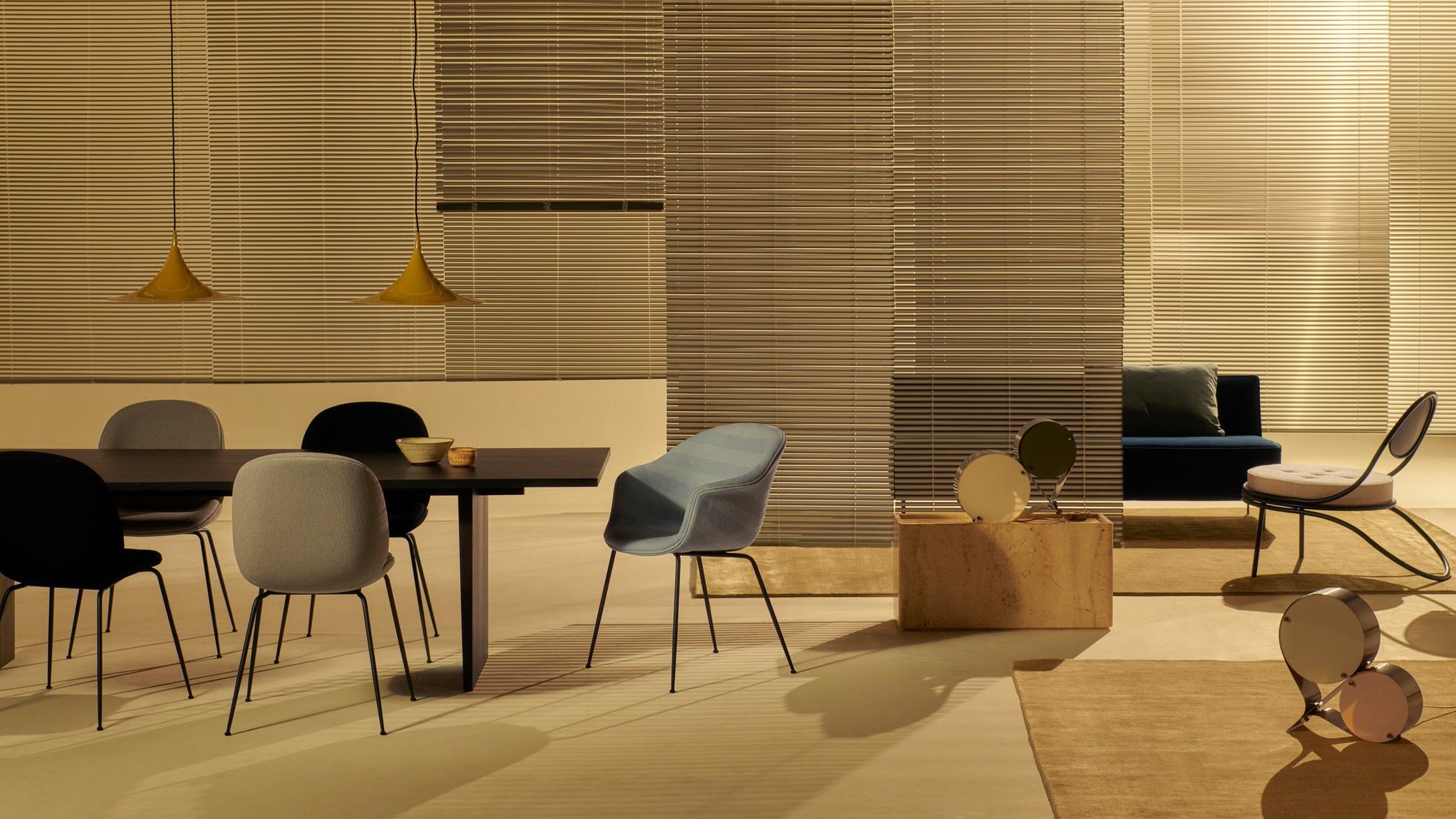 Upholstered BAT chair with a brass base