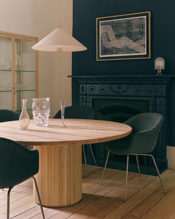 Upholstered BAT chair with a brass base