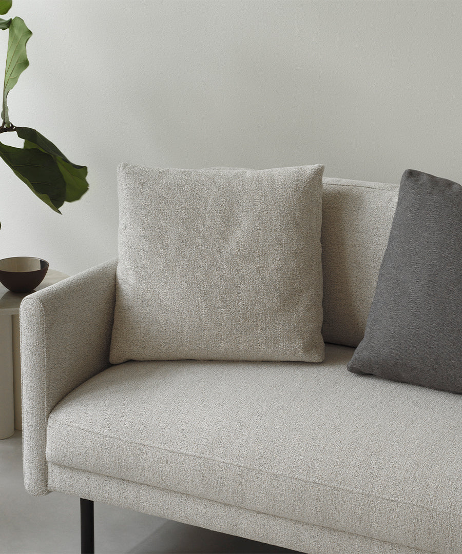 Light gray rar sofa with a black base