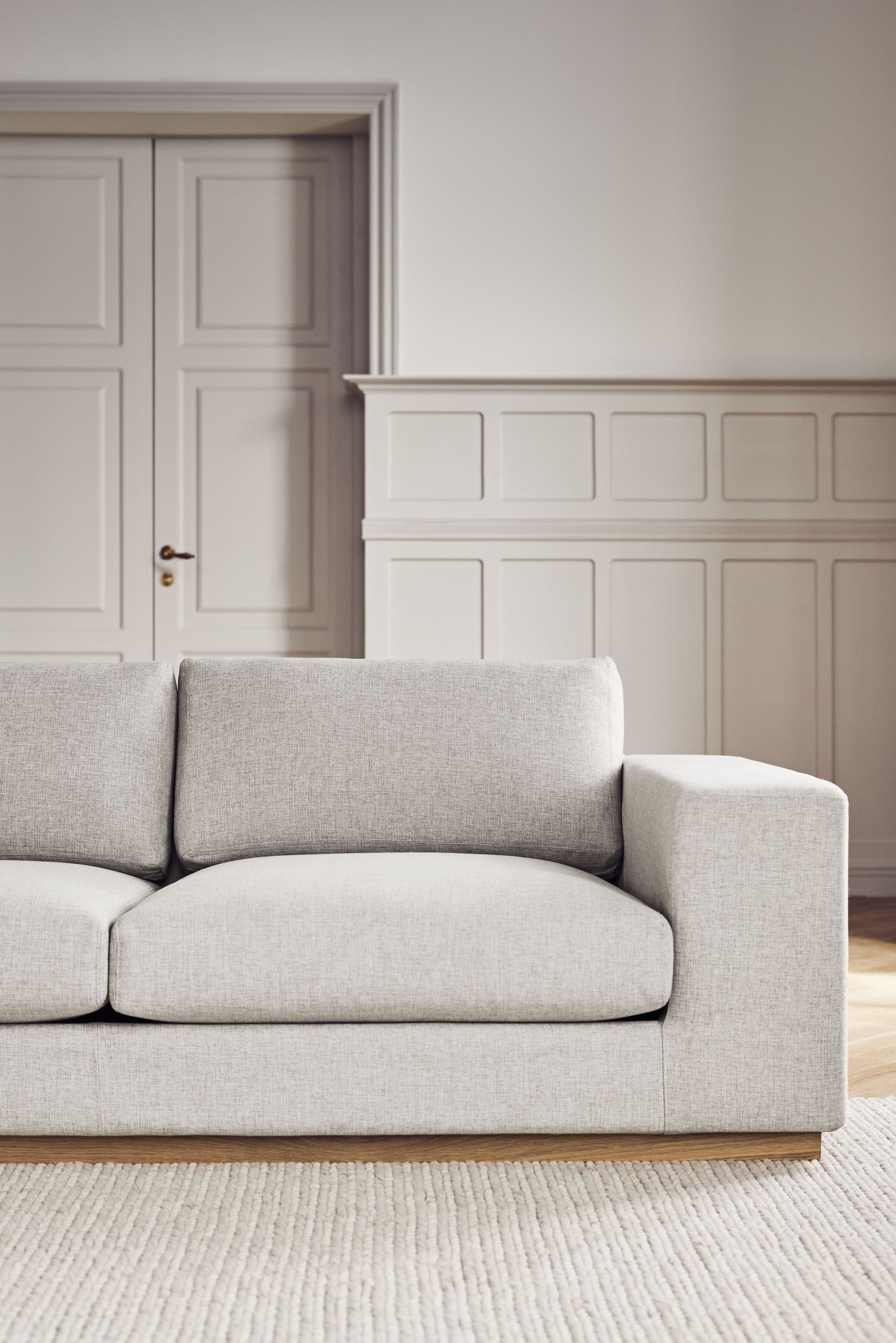 A corner with a left -hand sepia chaise with an oak base