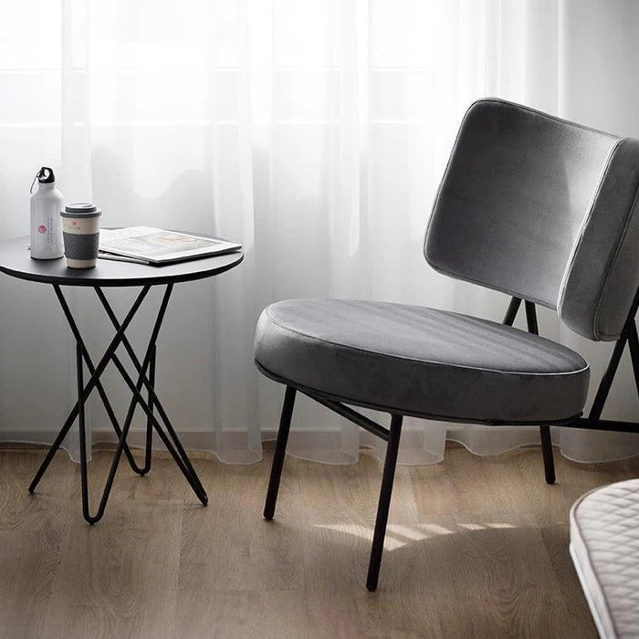 Upholstered COCO armchair with a black base
