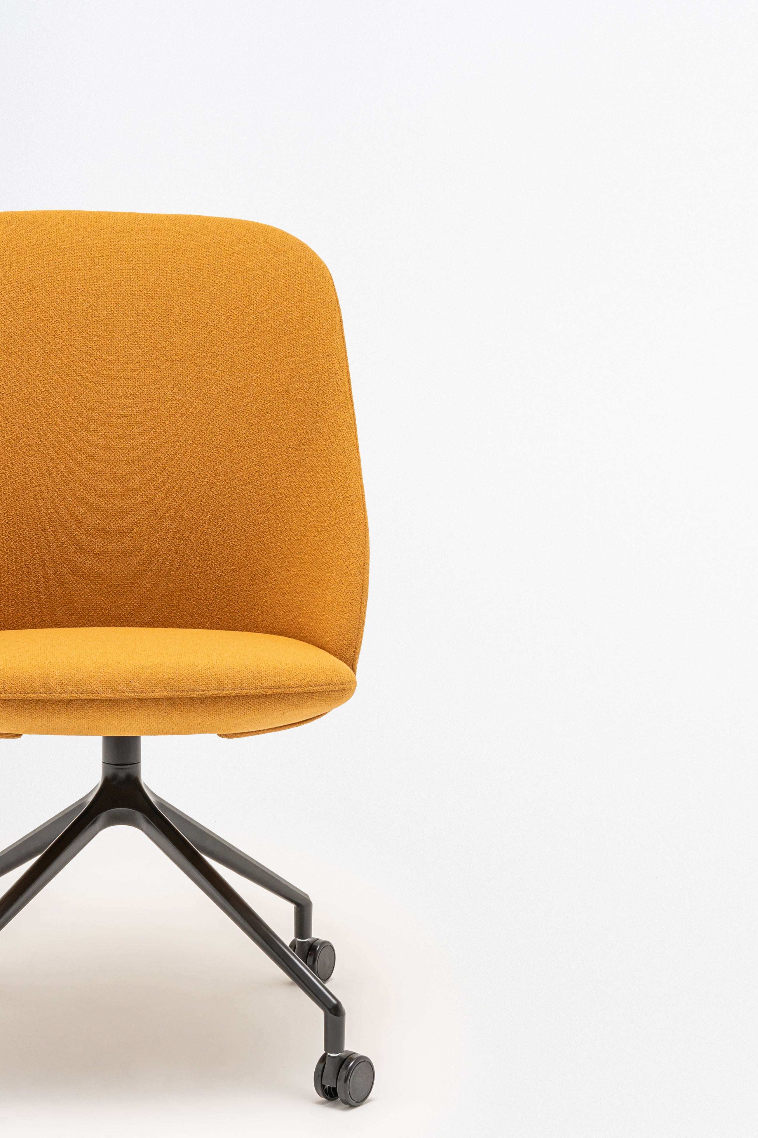 Rotable armchair with a high back, a metal parallel base with wheels to a soft surface