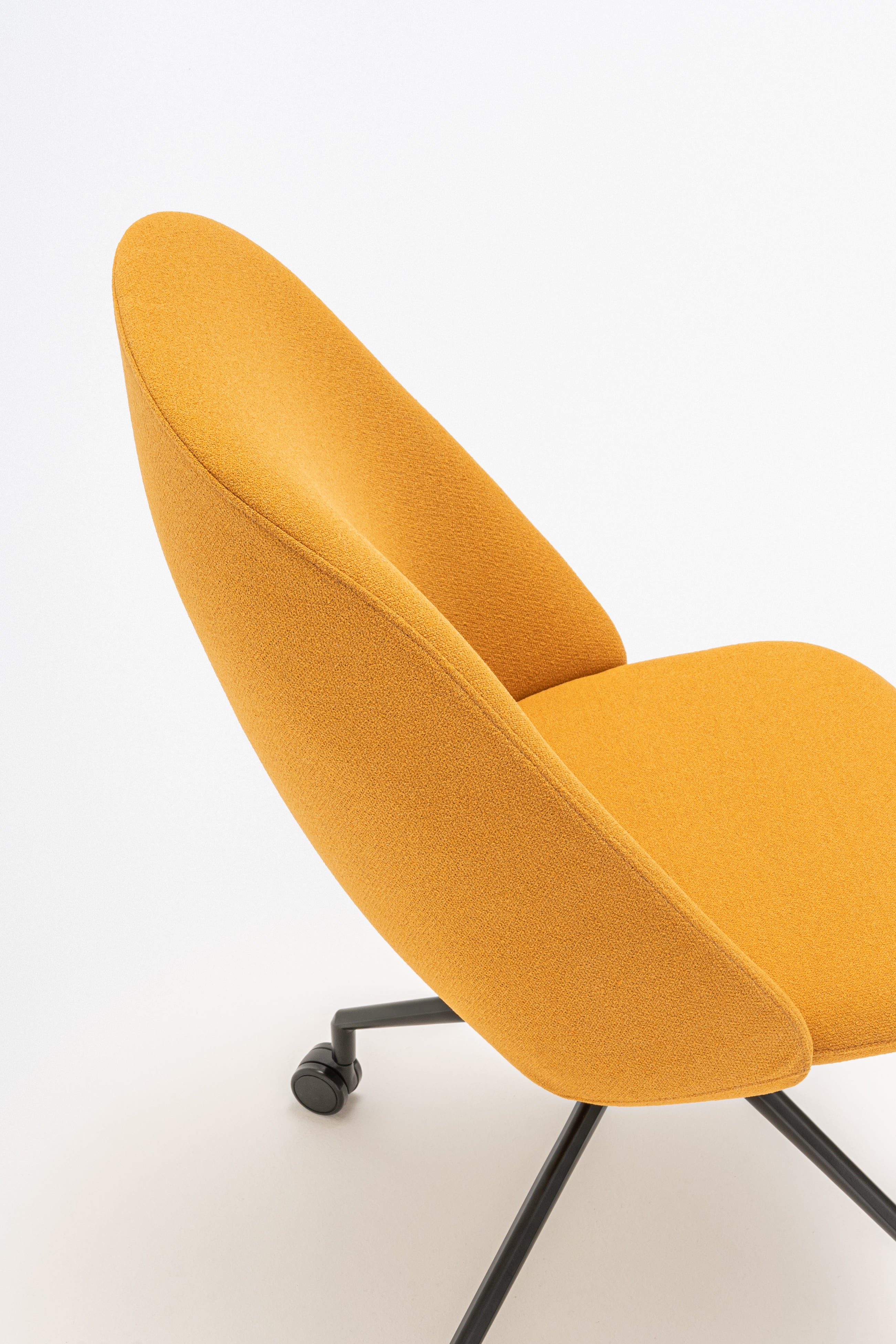 Rotable armchair with a high back, a metal parallel base with wheels to a soft surface
