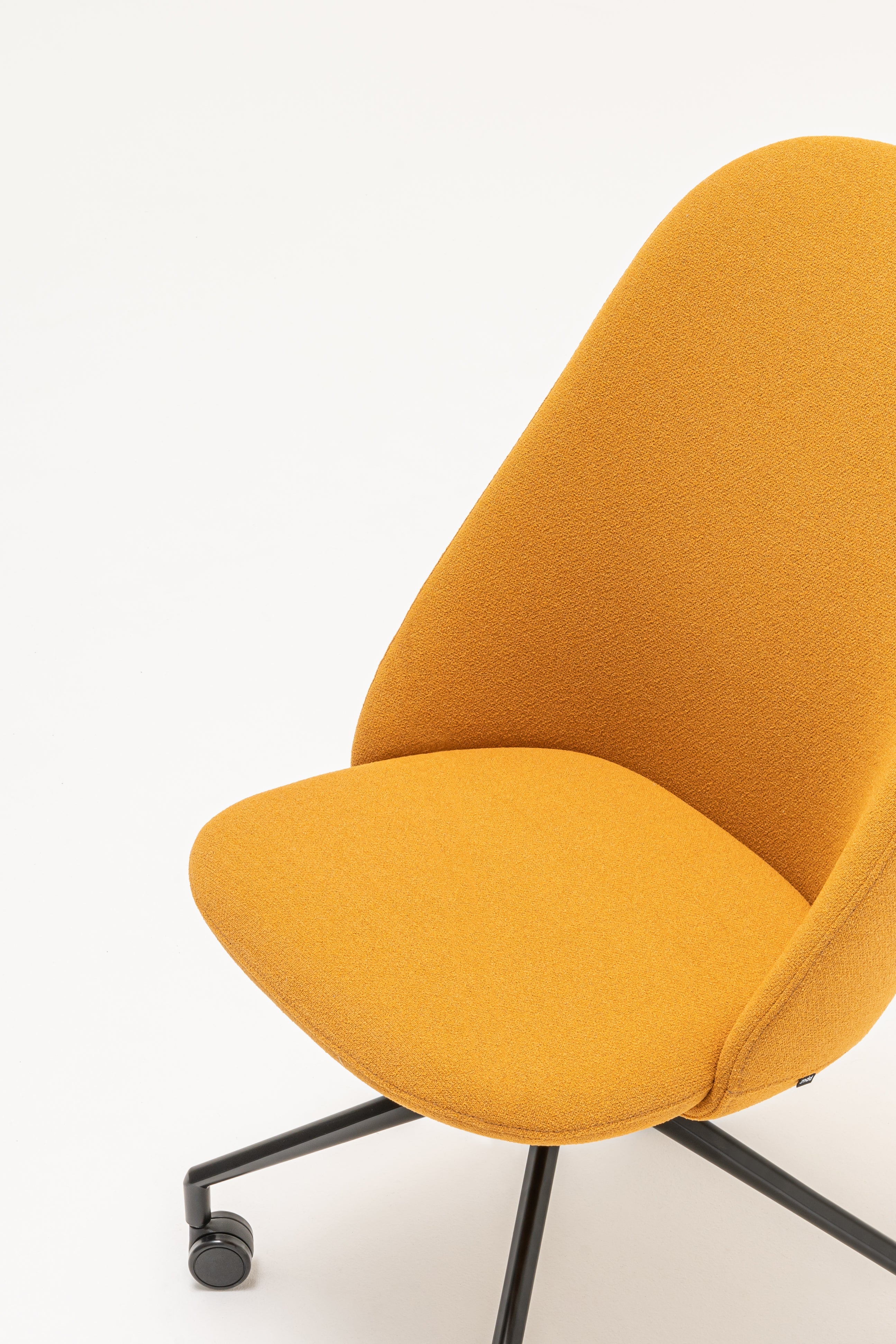 Rotable armchair with a high back, a metal parallel base with wheels to a soft surface