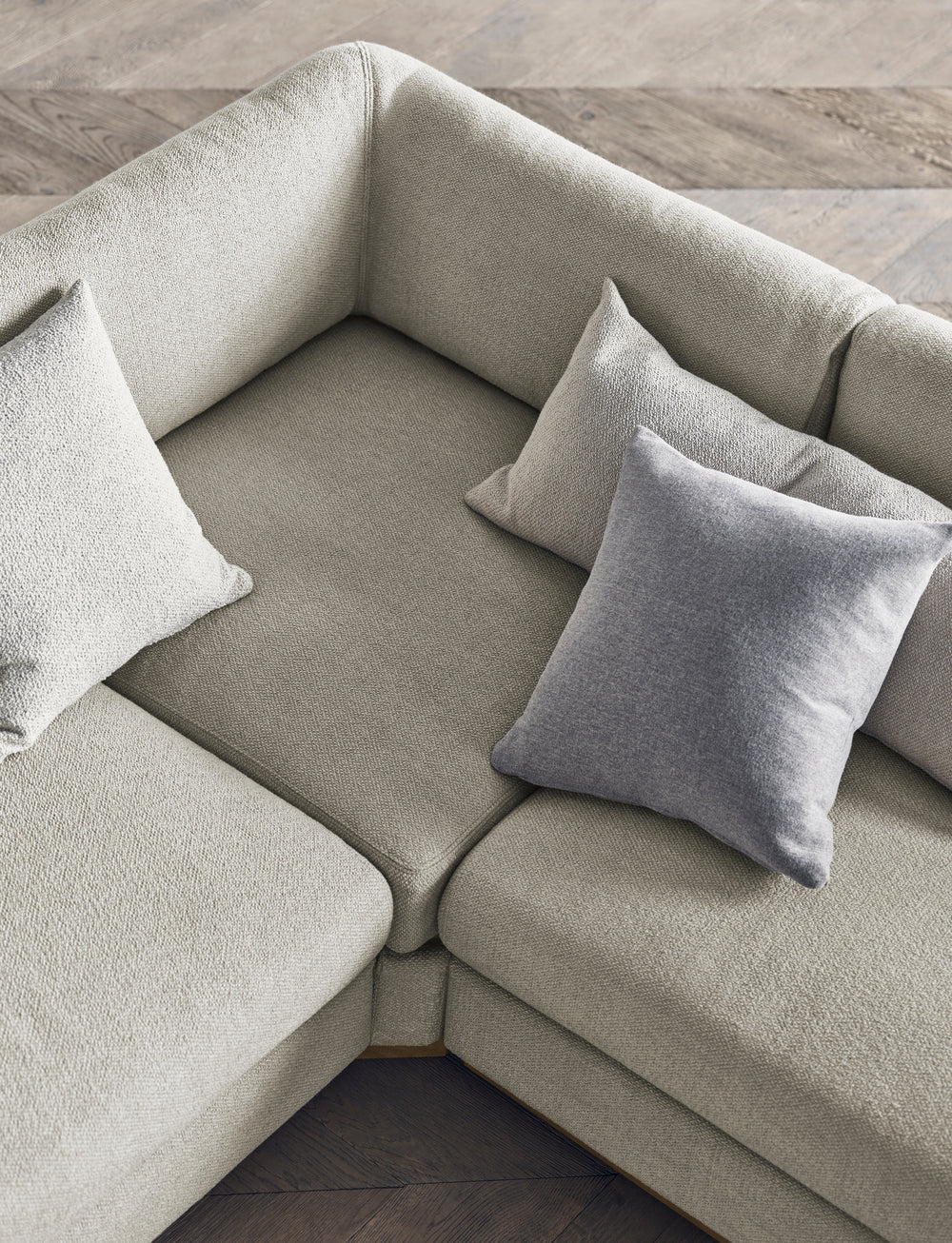 A corner with a left -hand sepia chaise with an oak base