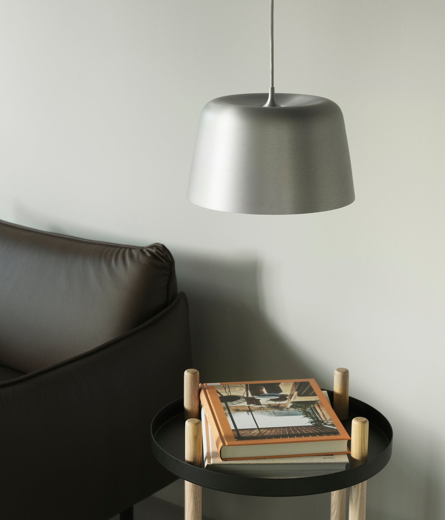 A wheelchair on wheels, a round black block with ash legs