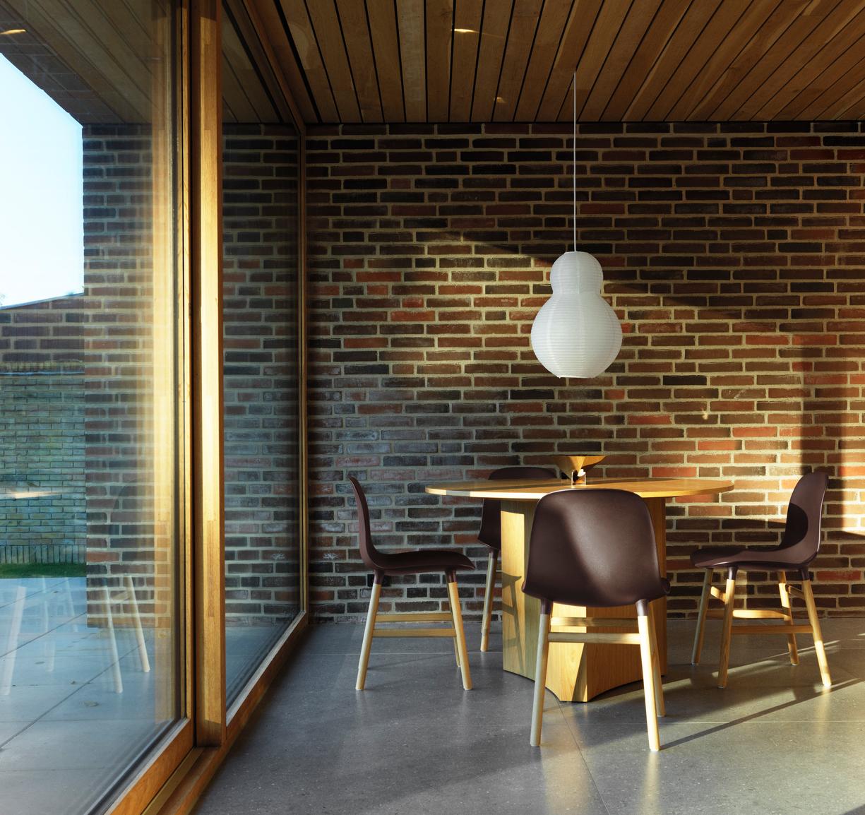 A chair of brown forms with a black oak base