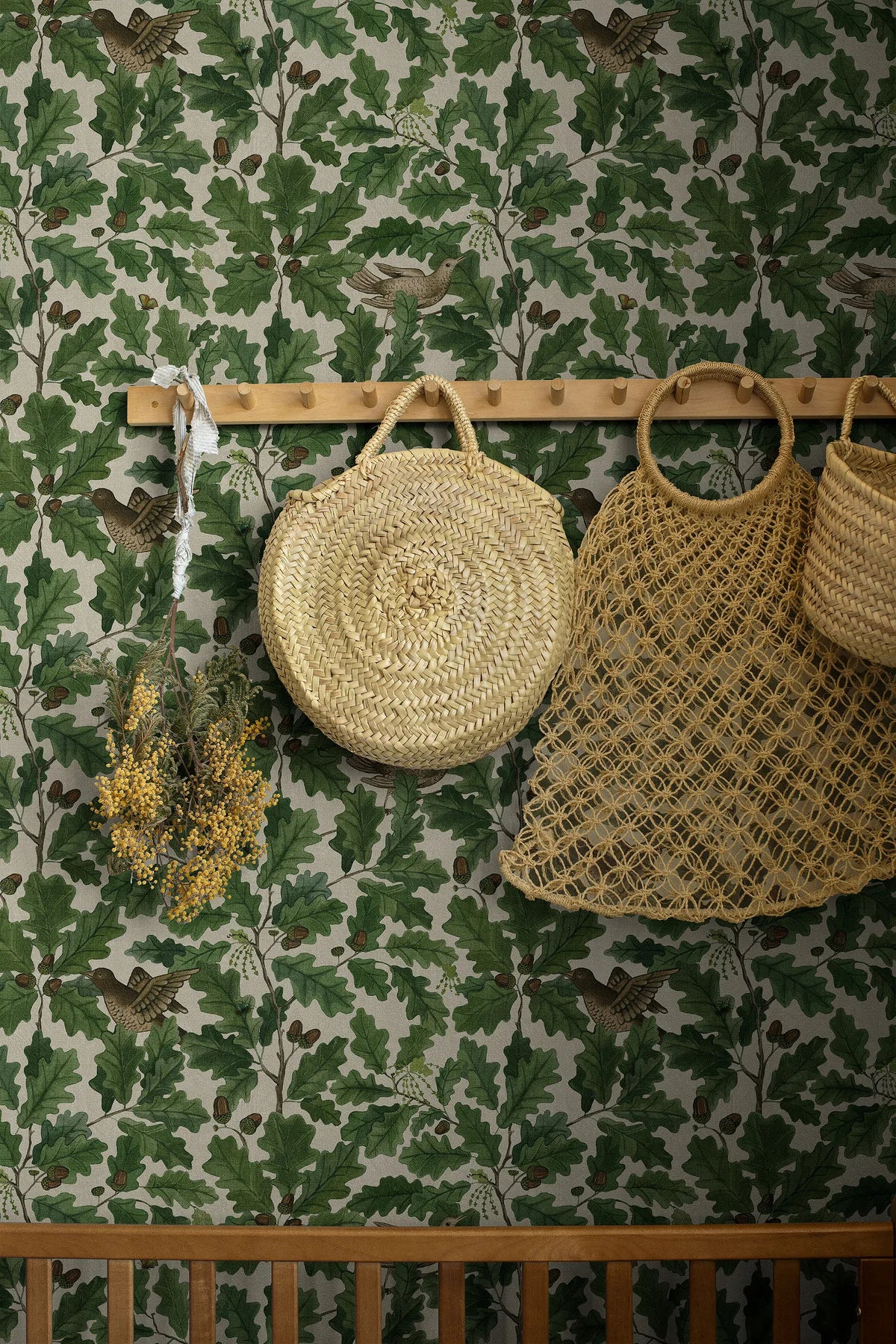 Wallpaper with a plant motif of leaves and birds IN THE OAK green with white
