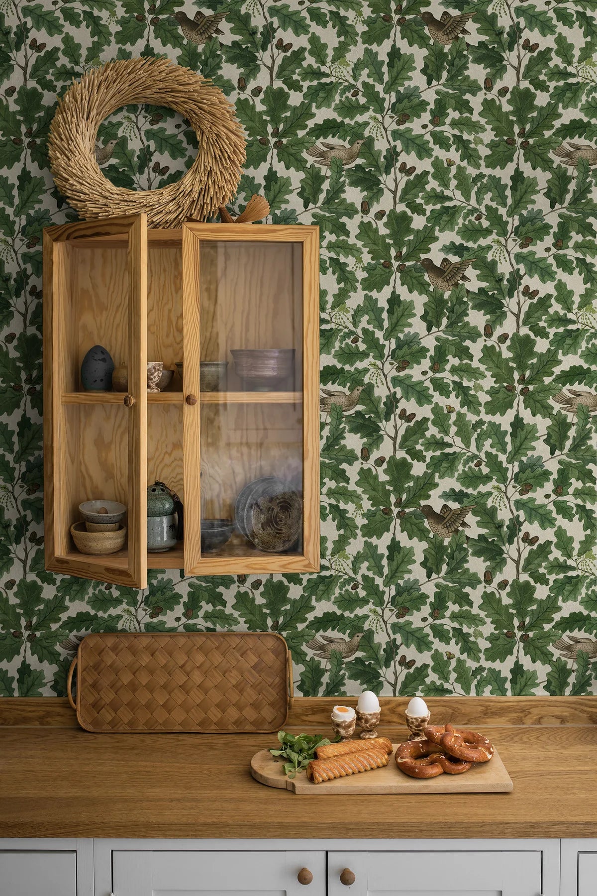 Wallpaper with a plant motif of leaves and birds IN THE OAK green with white