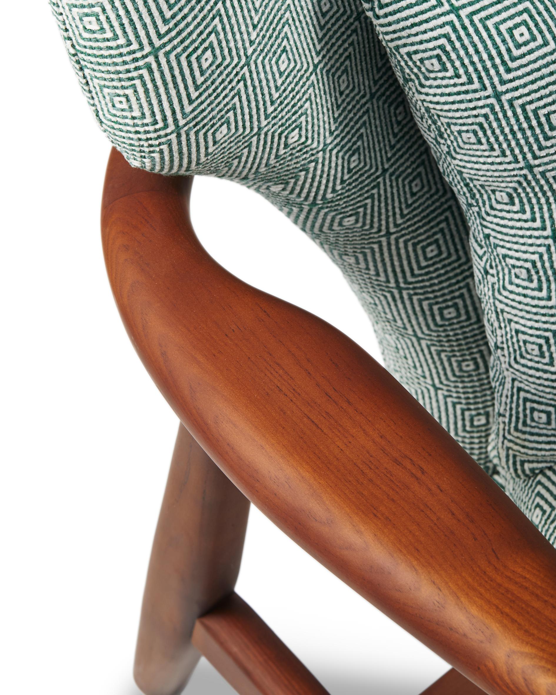 PEGGY armchair in green with geometric patterns and a wooden base
