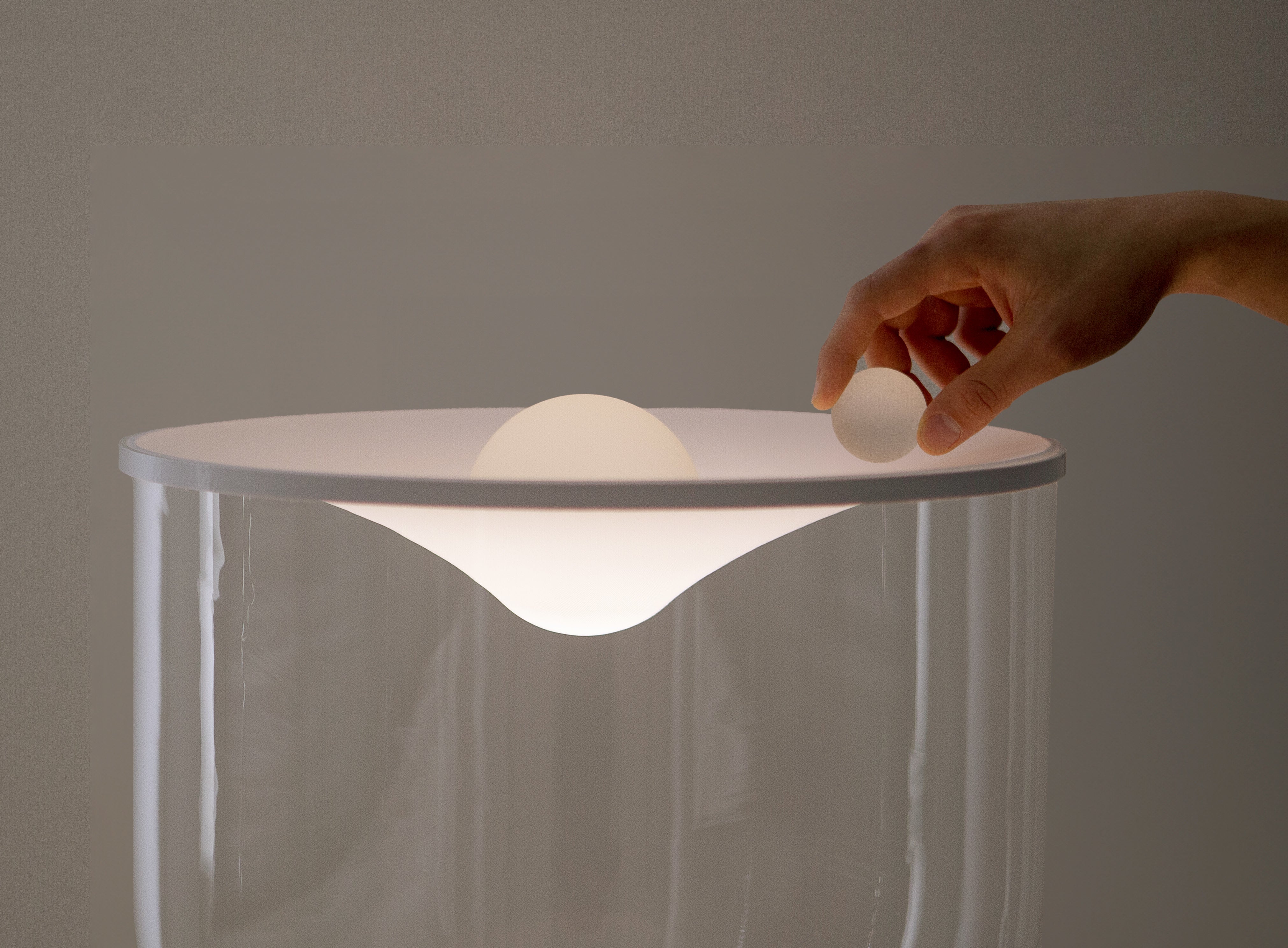 GRAMMOLUCE table lamp with a glass shade and black base.