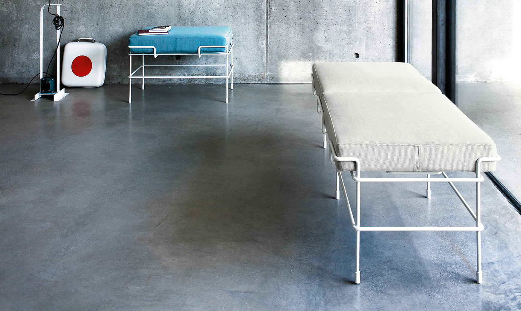 TRAFFIC upholstered bench with a white steel base