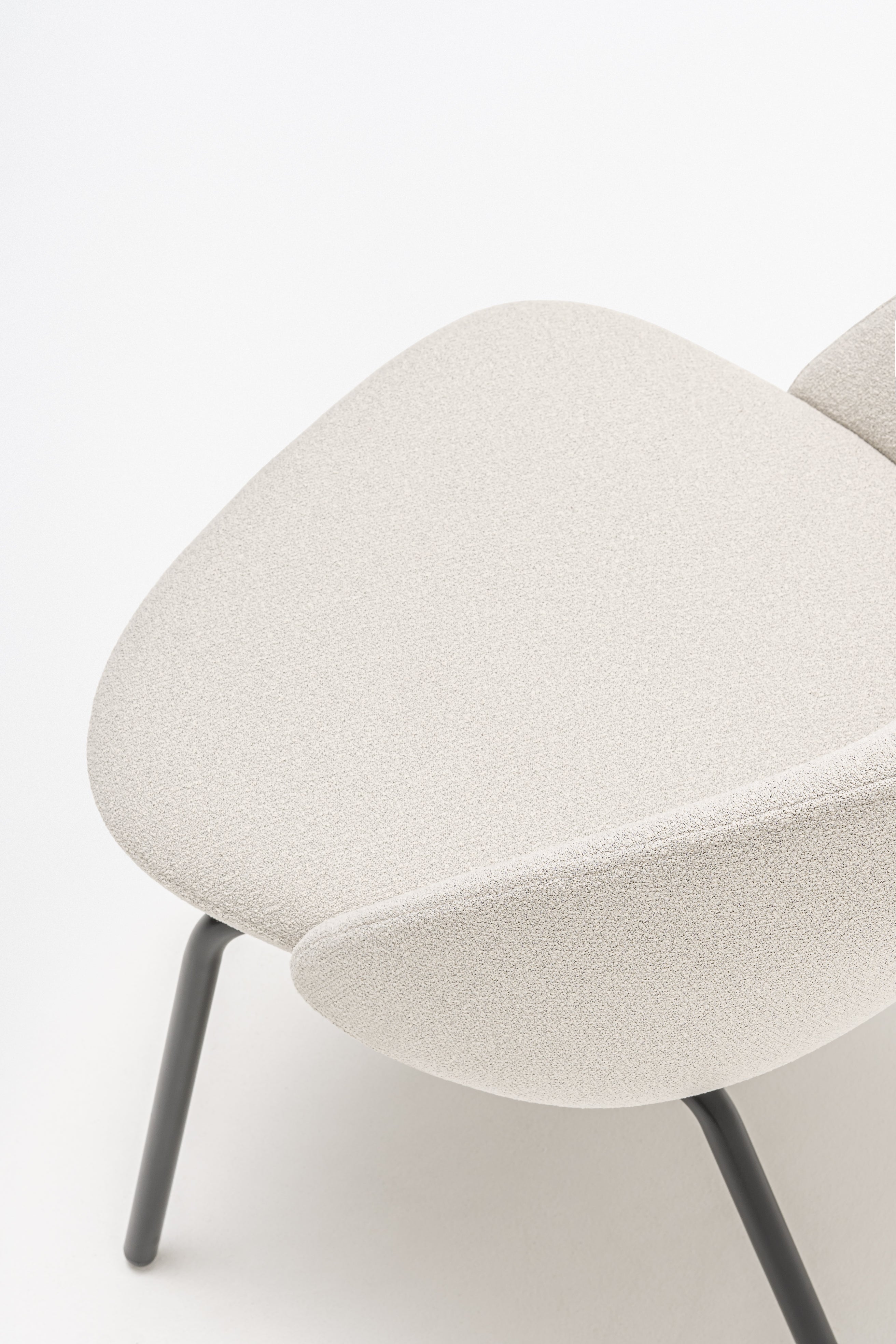 Armchair with low backrest parallel four -legged base