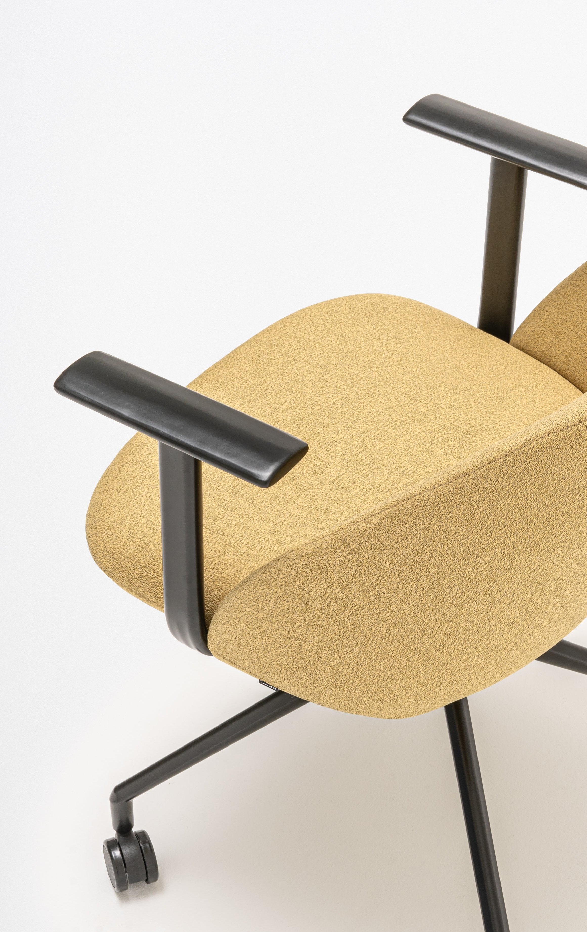 Rotable armchair with a high back parallel metal base with wheels to a hard surface