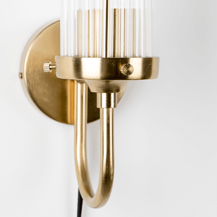 Modern acrylic design tubes are complemented by a matte brass wall finish. Thanks to our fashionable Angel On Fire wall lamp, you can softly and stylishly illuminate the wall in the gallery or add the glow of empty wall space. Style that